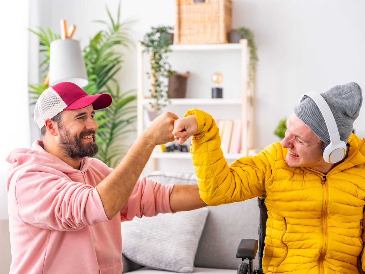 A support worker and participant sharing a happy moment at home